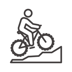 マウンテンバイクで坂を駆けあがるアイコン